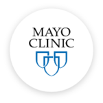 Logo of Mayo Clinic featuring two blue shields with a "Mayo Clinic Weight Goals" text above in a circle with black background.